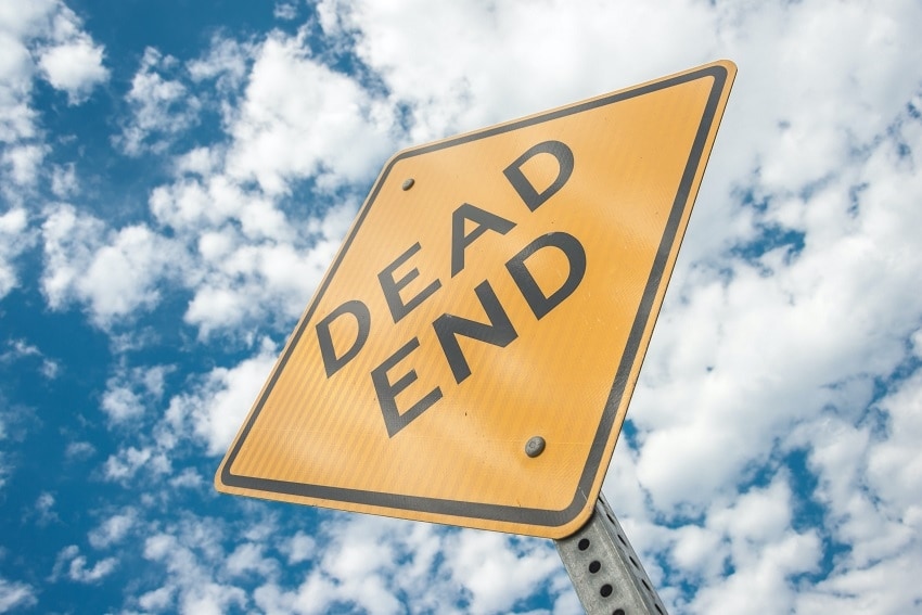 View of Street Sign Reading 'Dead End' from Below Against Cloudy Blue Sky