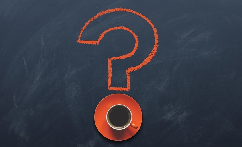 Orange question mark etched onto chalkboard surface, with orange saucer dot holding coffee mug
